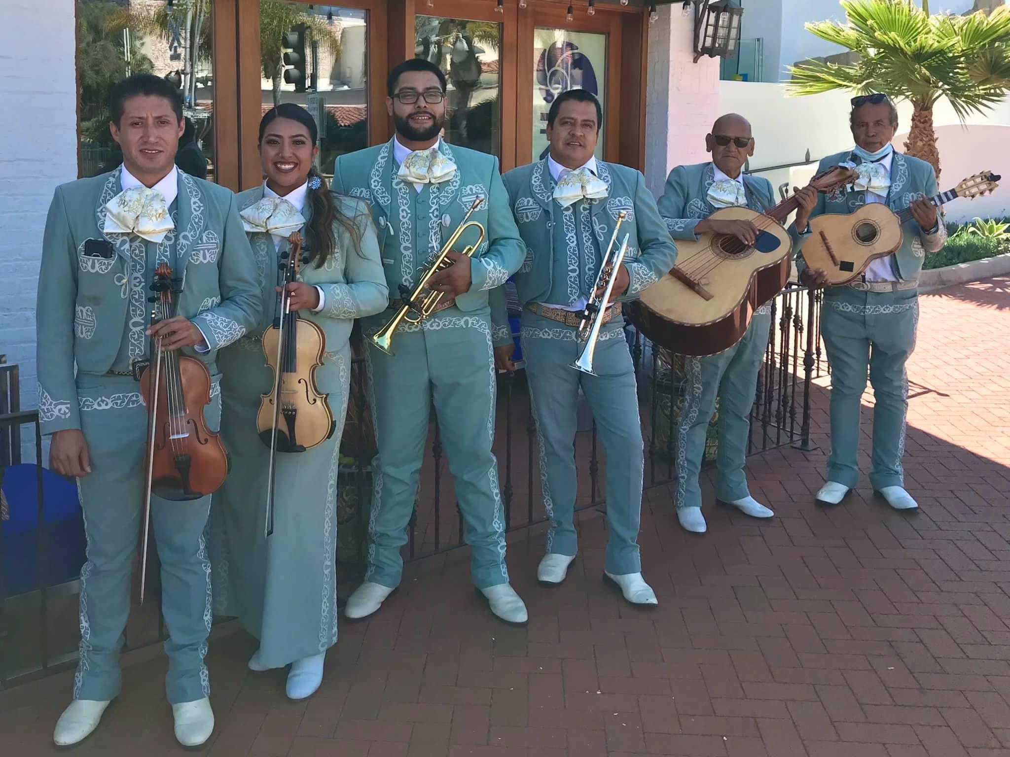 Mariachi Real De Oxnard performing in turquoise suits