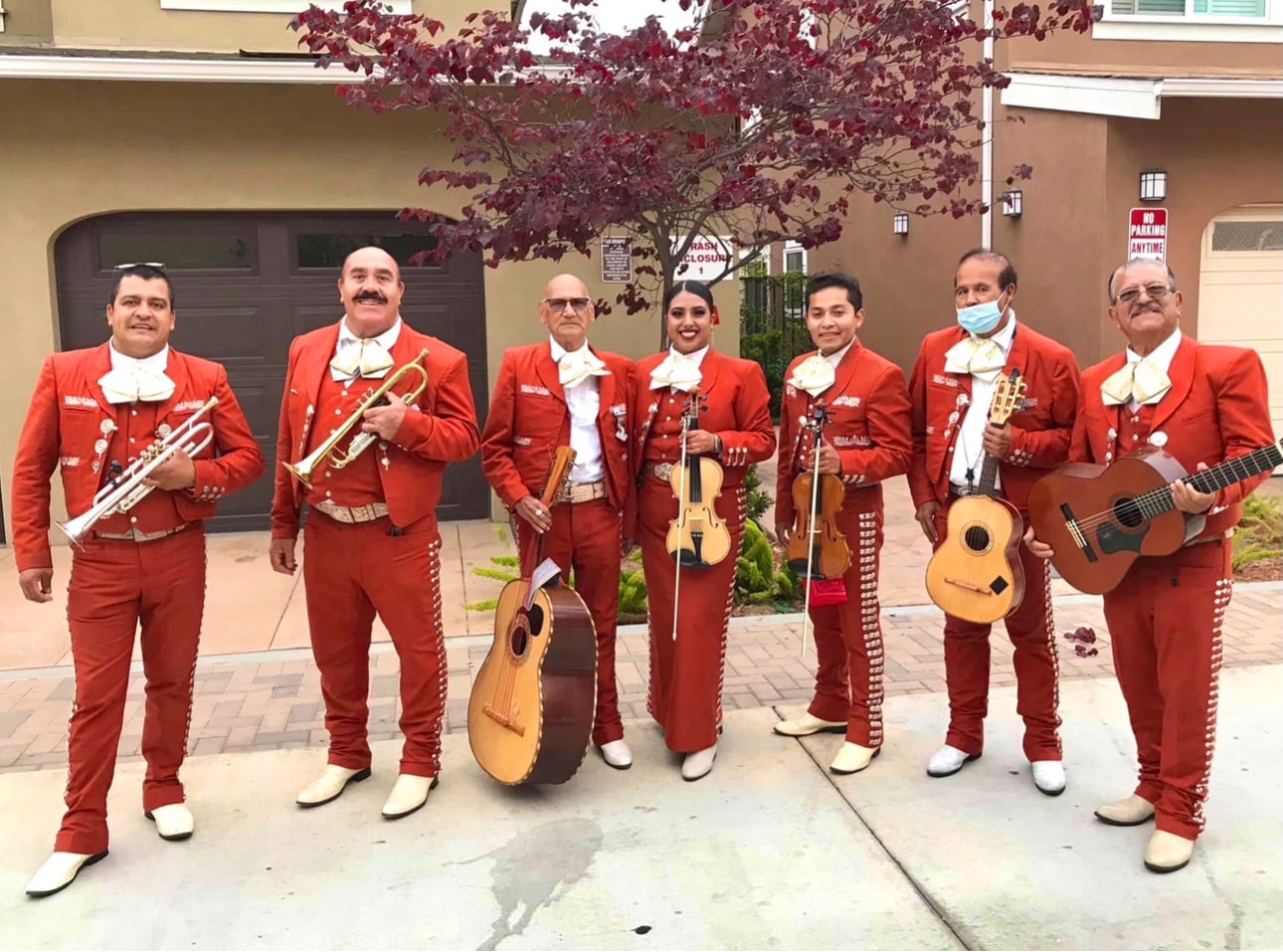 Mariachi Real De Oxnard in red suits holding instruments